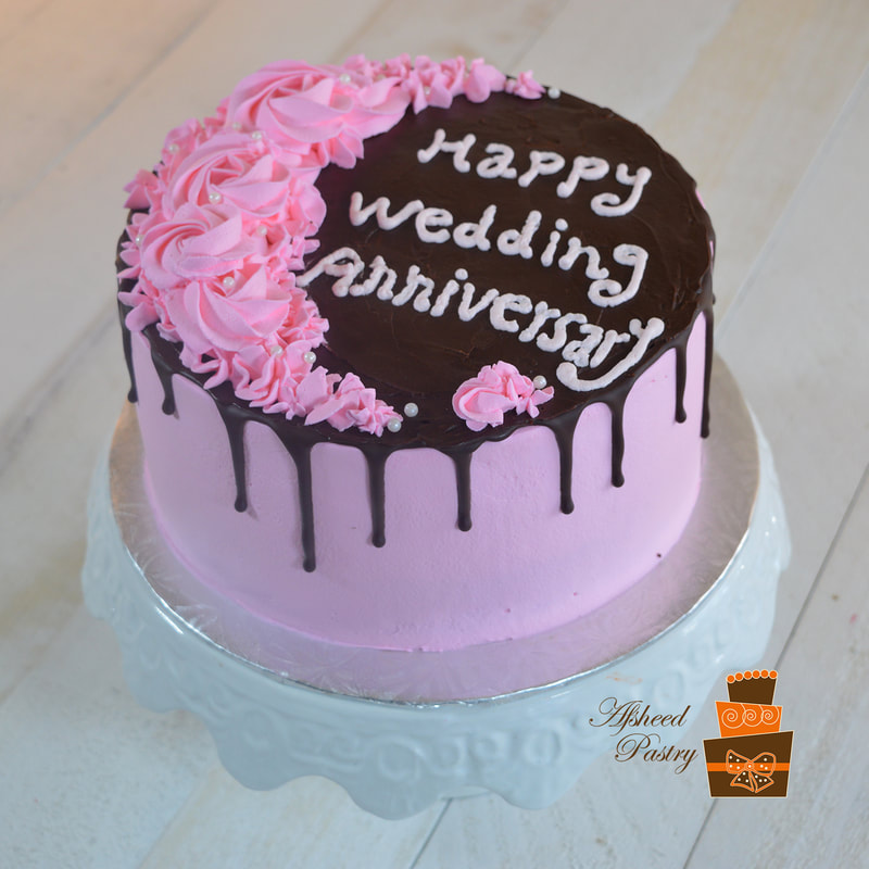 Pretty pink anniversary cake with chocolate drip on top
